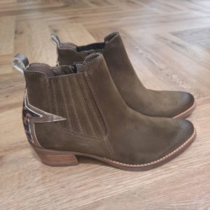 Boots Gael Taupe Découvrez les boots Gael Taupe de la marque MKD Jolie bottine style santiag avec son talon biseauté de 5cm. Originale avec son étoile sur l'arrière. De fabrication portugaise vous choisissez une chaussure dessus et doublure cuir, avec une promesse de confort et d'élégance. Ils accompagneront vos tenues "bohème" idéalement. La marque MKD est une marque de chaussures pour femme Made in Portugal dont le souci principal est le confort. A travers les collections, MKD créé des modèles stylés, confortables et de qualité afin de satisfaire toutes les femmes d'aujourd'hui. Avec un savoir-faire qui n'est plus à prouver, la marque portugaise a su se démarquer et se faire une place de choix dans le monde de la chaussure. Il y en a donc pour tous les goûts chez MKD, du sobre, de la modernité, du sport chic, du casual, ou encore de la féminité. La marque MKD est synonyme de sophistication et de modernité, offrant des chaussures conçues pour les fashionistas qui cherchent à se démarquer. Chaque paire est élaborée avec des matériaux de haute qualité et un design avant-gardiste, alliant confort et élégance. Les chaussures MKD sont parfaites pour toutes les occasions, que ce soit une journée au bureau ou une soirée entre amis. Leur design unique et leur finition impeccable en font un choix idéal pour ceux qui ne veulent pas sacrifier le style pour le confort. Découvrez l'art de la chaussure avec MKD, où chaque modèle raconte une histoire de passion et de créativité. Les collections MKD se distinguent par leur originalité et leur capacité à transformer n'importe quelle tenue.