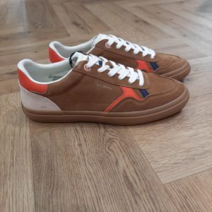Travis Retro Camel Les chaussures Pepe Jeans Travis Retro Camel sont parfaites pour un style décontracté et urbain. Ces chaussures vulcanisées ont une empeigne en croûte de cuir, un col rembourré, notre logo emblématique sur le côté avec des combinaisons de matériaux et de couleurs, une semelle en caoutchouc avec une marque et un logo classique sur le côté. Histoire de la marque En 1973, trois frères Nitin Shah, Arun Shah et Milan Shah, ouvrent une petite « jeanerie » sur le marché de Portobello Road, à l'ouest de Londres, afin de vendre leurs créations. Les frères Shah rencontrent un franc succès, si bien qu'en 1975 ils possèdent quatre boutiques à travers la capitale londonienne. Nous sommes une marque emblématique, synonyme de denim et d'une créativité sans limites . Pepe Jeans London vous offre les bases pour rayonner de confiance en vous, d'unicité et d'authenticité. Dans les années 80, Pepe Jeans est numéro un du marché anglais du jean, devançant ses concurrents américains. C'est ainsi que la marque s’attaque à l’international; aux États-Unis pour commencer où elle implante des bureaux et y ouvre une boutique (1984). L'entreprise Pepe Jeans a ensuite été rachetée par l'espagnol Vicente Castellano en 1989. Les années 1980 seront des années de développement pour l'entreprise. De célèbres groupes tels que les Smiths entrent sous contrat avec la marque pour des campagnes de pub. En 1992, Pepe Jeans introduit son logo actuel.