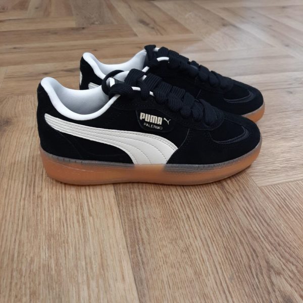 Palermo Moda Black Tout droit sortie de nos archives, voici la Palermo Moda Black. En effet, lancée dans les années 80, la légende de la culture Terrace fait son grand retour pour les jeunes fans, cette fois en version Moda. Tout d'abord, avec sa fameuse forme en T et sa semelle en gomme classique, cette version présente une tige en daim. Puis, elle possède une bande PUMA Formstrip en synthétique et un outillage translucide. Pour conclure, une basket à adopter d’urgence pour un outfit tendance et élégant. Tu peux aussi l'habiller de façon plus décontractée pour obtenir un look plus chill. La marque Puma est une marque de sneakers, de vêtements et d'accessoires de sport créée en Allemagne en 1948. Son origine remonte à 1924, date à laquelle Rudolf Dassler (son créateur) et son frère Adolf (dit "Adi") commencent à fabriquer des baskets de sports. Les deux frères se disputeront et créeront chacun leur marque de leur côté à partir de 1948. Ainsi,  Adi poursuivra l'activité initialement sous le nom d'Adiads et Rudolf créera Puma. La marque au "gros chat" s'illustrera avec ses crampons vissés qui équiperont des sportifs de premier plan. Elle est à l'origine de nombreux modèles de baskets mythiques comme la Puma suede, la Clyde et la Court Star. Plus récemment, Puma a bénéficié d'une exposition exceptionnelle grâce aux exploits d'Usain Bolt qu'elle équipe. Aujourd'hui encore, Puma continue à innover en lançant de nouveaux modèles aux lignes parfois futuristes comme la Blaze, la Mantra, la Tsugi, la RS-X.