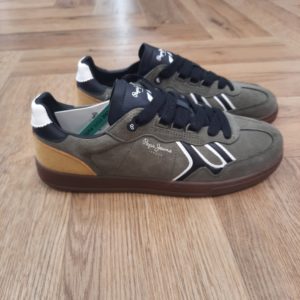 Baskets Ball Green- pepe jeans ball mix kaki-Histoire. En 1973, trois frères Nitin Shah, Arun Shah et Milan Shah, ouvrent une petite « jeanerie » sur le marché de Portobello Road, à l'ouest de Londres, afin de vendre leurs créations. Les frères Shah rencontrent un franc succès, si bien qu'en 1975 ils possèdent quatre boutiques à travers la capitale londonienne