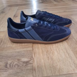 Pulse Deep Blue-sneakers caval pulse navy-Le modèle de basket écoresponsable Pulse sont des sneakers asymétriques qui mélangent un look sportswear à l'élégance des paires de handball des années 90. Un modèle retro et confortable couleur honey espresso ! Elles sont confectionnées entièrement en Europe, au Portugal, avec des matériaux éco-responsables, traçables et labellisés. Chaque détail, du bout golf, à la plaque perforée, en passant par les découpes croquet, le cousu Strobel, le lacet tricot et les semelles en gomme affûtées, évoque un style rétro-preppy sophistiqué. Souples et flexibles, elles promettent confort et allure pour toutes vos tenues. Trouvez les 7 différences !