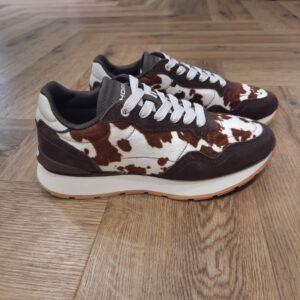 City Cow Print Brown Notre iconique silhouette City Cow Print Brown réimagée dans une combinaison raffinée de poulain, cuir nappa et daim, fusionnant des textures riches avec une finition soignée et élevée. Puis, cette sneaker est dotée de semelles ton beurre au caractère vintage, d'un logo en relief sur la languette et du branding HOFF sur le stabilisateur. Ainsi, elle est conçue pour le confort : talon rembourré, languette flexible et semelle intérieure Memory-Foam pour une ajuste adaptable. La marque Fondée en Espagne en 2017, HOFF est née de la conviction que chaque pas est une opportunité de créer, découvrir et affirmer sa personnalité. HOFF est une marque contemporaine de sneakers qui marie un design intemporel et élégant avec une polyvalence audacieuse. Reconnue pour sa créativité raffinée, son attention aux détails et sa maîtrise unique des couleurs, HOFF crée des sneakers qui s’adaptent aux transitions de la vie, transformant chaque instant du quotidien en une expression de style et de sens. Inspirée par le mouvement et la curiosité, HOFF célèbre l’individualité et l’expression de soi à travers le design. Son esthétique distinctive équilibre sophistication et modernité, brouillant les frontières entre le décontracté et le raffiné, tout en restant fidèle à ses valeurs de connexion, d’authenticité, de passion et de créativité.